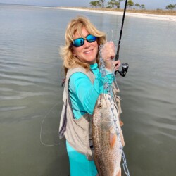 Jamie's 25" Redfish! Great fighter! Notice the latex gloves...I can't figure out if it's the bay water or the shrimp that my hands are reacting to. The gloves help a lot!